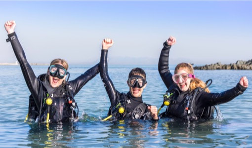 3 Divers celebrating after a day of scuba diving in Komodo National Park